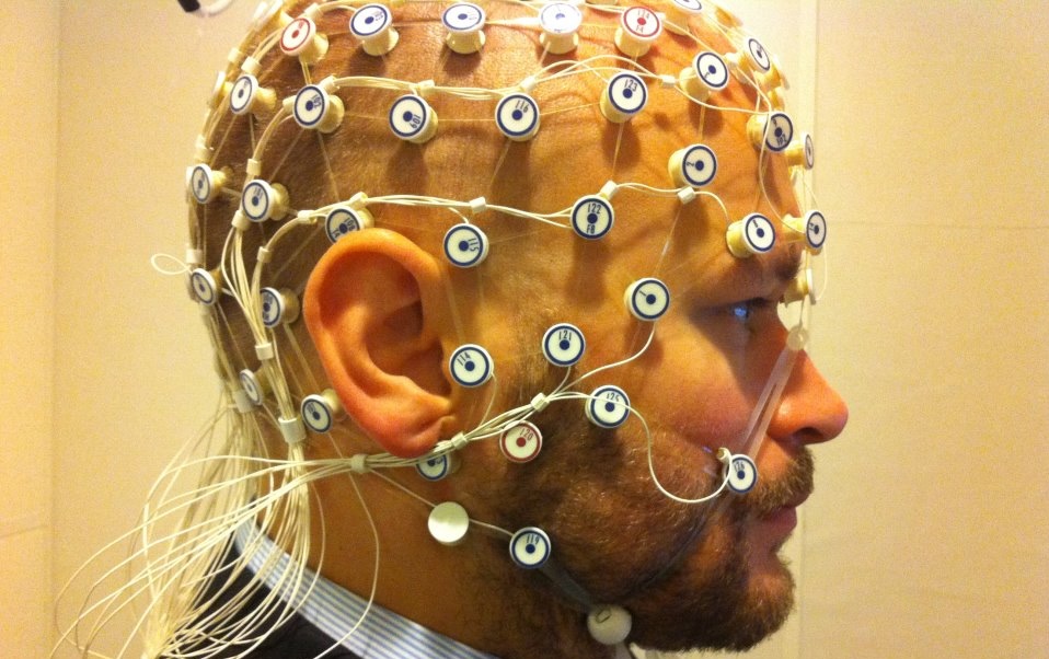 Image showing a man with EEG sensors all over his head and face